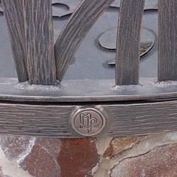 A wrought-iron dome on the well  detail of the UKOVMI logo
