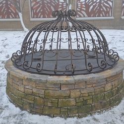 Forged well cover, crafted for afamily home in the region of Orava