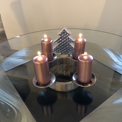 Aforged Christmas candle holder suitable for amodern style interior, treated by polishing and varnishing