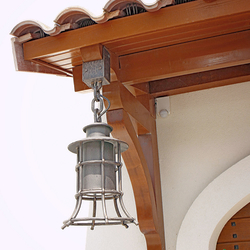 A wrought iron lamp with a shade