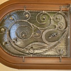 Forged ornamental grille on a family house door
