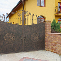 A wrought iron gate with a logo