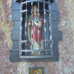 A wrough iron monument of st. Barbara with grille