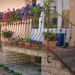  Wrought iron flower holders in an exterior railing