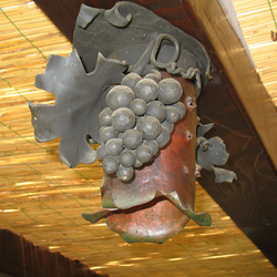 A wrought iron light in a wine cellar