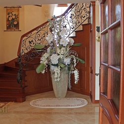 A wrought iron railing with a wooden handrail