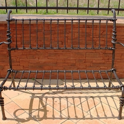 A wrought iron garden bench