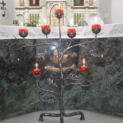 Artistic candleholder with a natural motif in a church in the east of Slovakia
