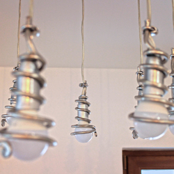 The detail of a luxury pendant lighting – A modern chandelier with handcrafted spirals