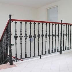 A historical forged railing - Cast iron railings with a wooden handrail in a historic house from the 16th century